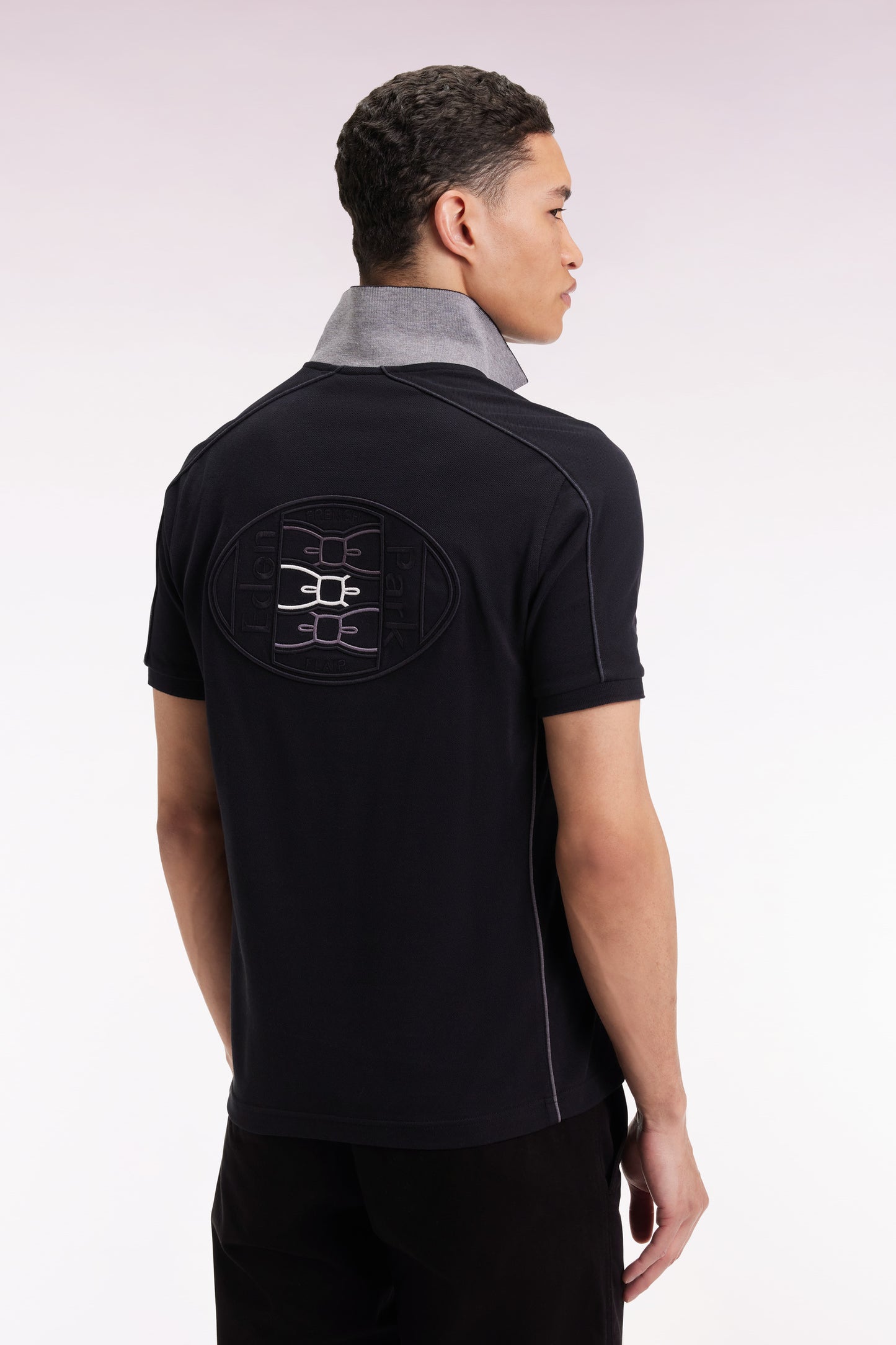 Short-sleeved polo shirt in black cotton piqué with colored piping