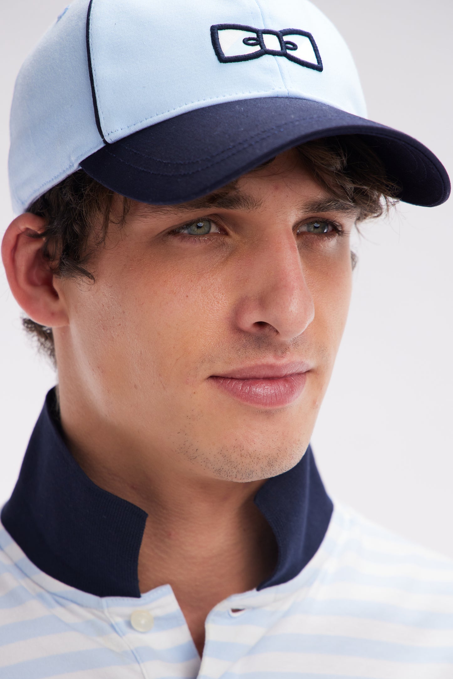 Sky blue cotton jersey cap with striped bow tie logo