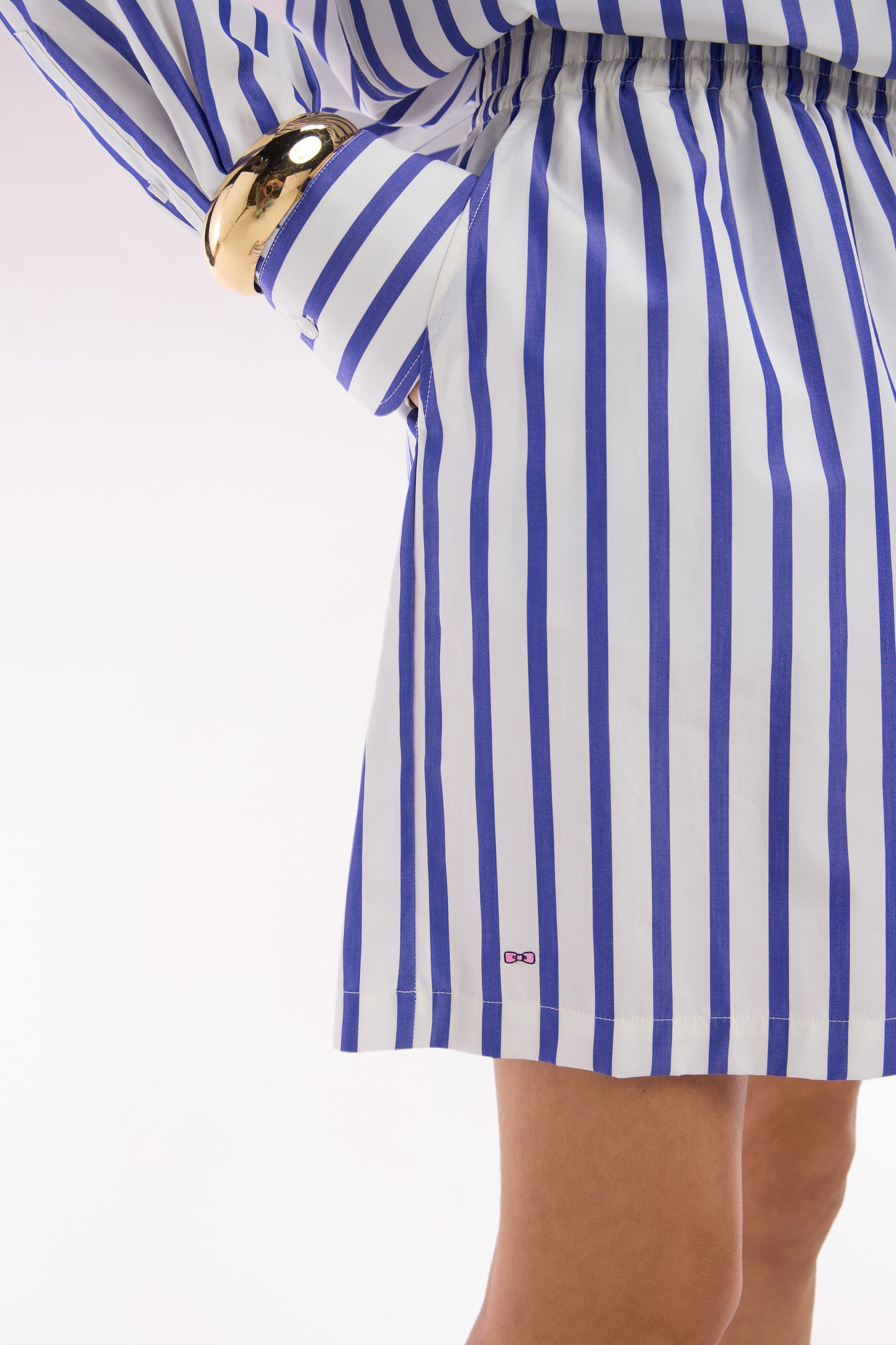 White oversized cotton shorts with blue stripes