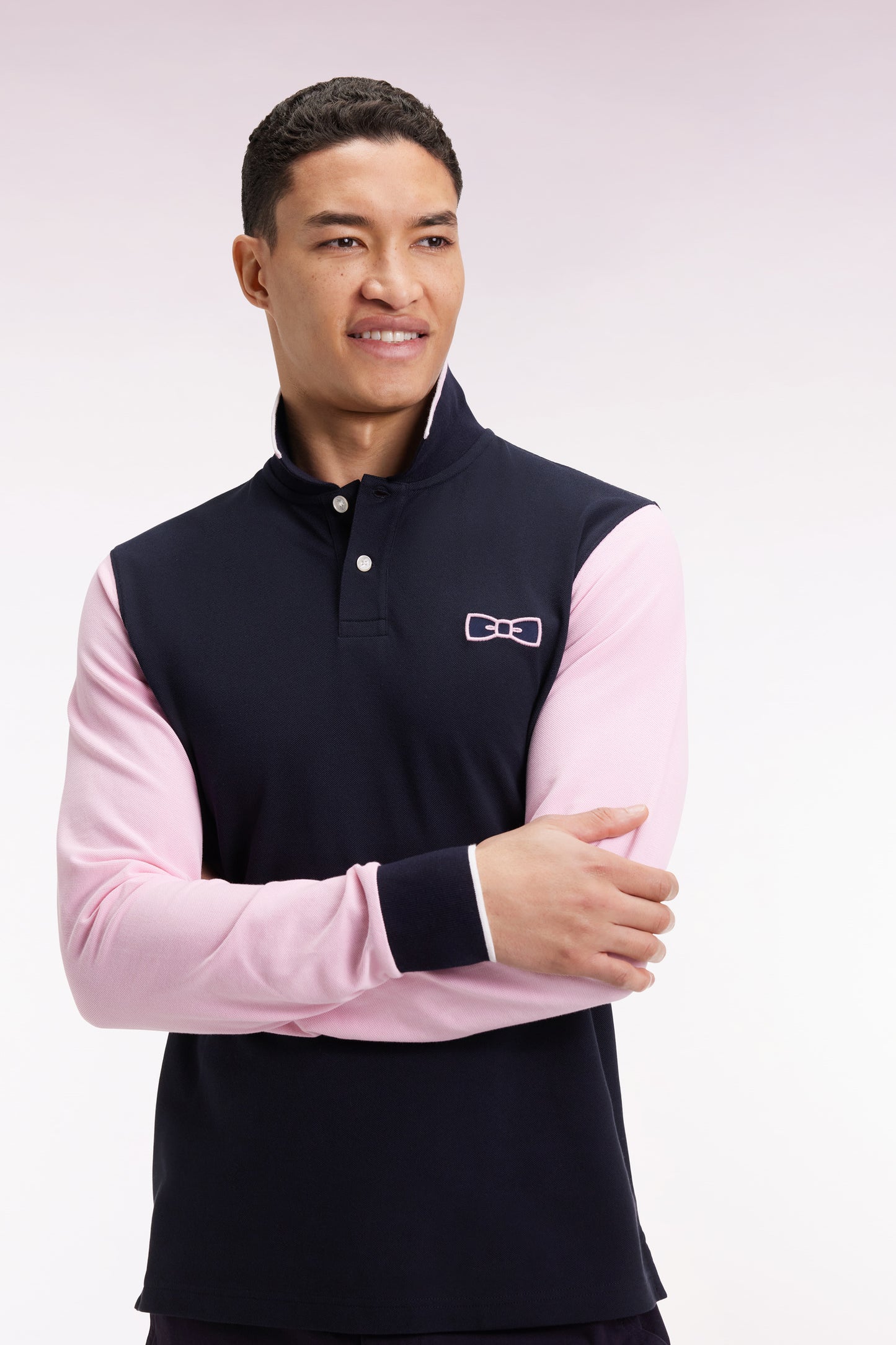 Two-tone navy and pink long-sleeved polo with bow tie
