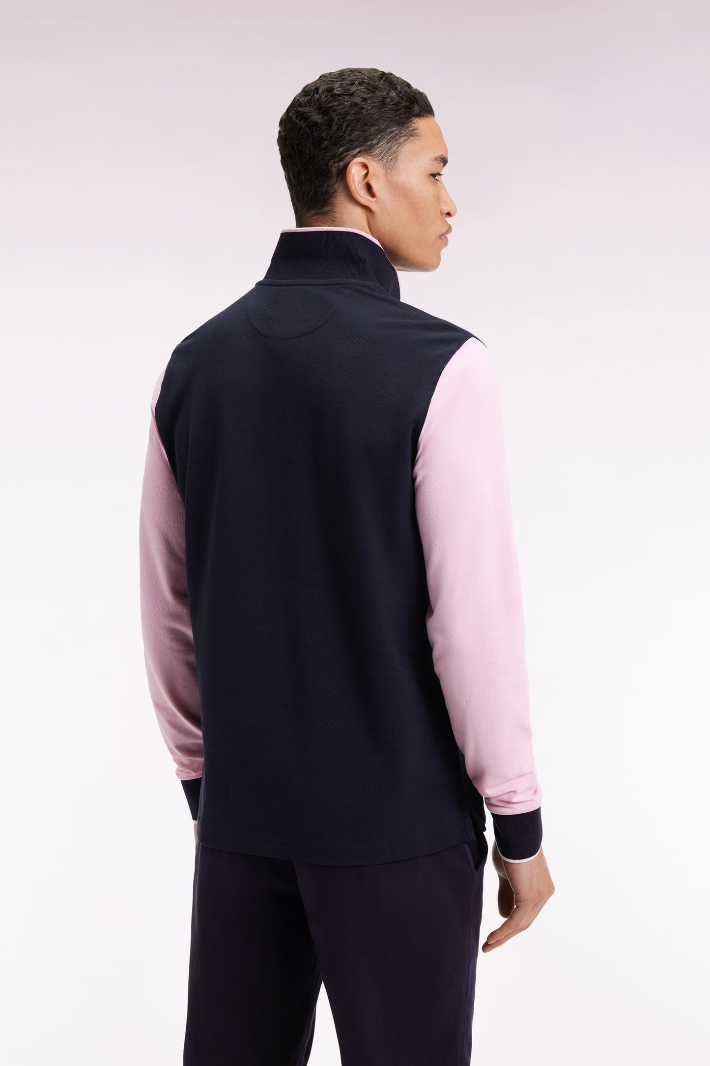 Two-tone navy and pink long-sleeved polo with bow tie
