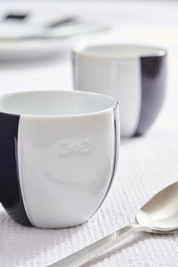 Set of two porcelain coffee cups with blue glazed interior